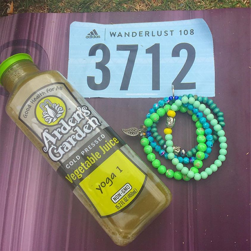 Yoga festival essentials - green juice, yoga mala sacred beads, and yoga a colorful mat